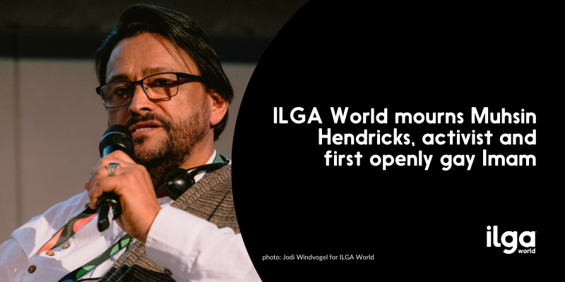 A photo shows Imam Muhsin Hendricks speaking from the stage of the 2024 ILGA World conference. Text reads: "ILGA World mourns Muhsin Hendricks, activist and first openly gay Imam". The ILGA World logo is placed at the bottom right of the image