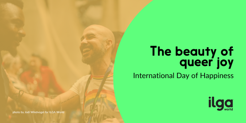Image of a participant at the 2024 ILGA World Conference in Cape Town South Africa smiling in the background with the text, "The beauty of queer joy: International Day of Happiness" on the right with the ILGA World logo below.