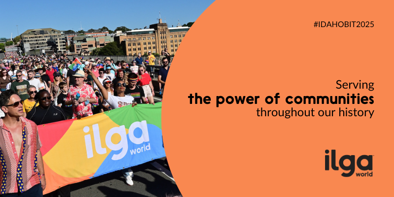 A group of people at the 2023 WorldPride march in Sydney, Australia. A woman holds an ILGA World banner. Text reads: "IDAHOBIT 2025. Serving the power of communities throughout our history". The ILGA World logo is placed at the bottom right of the image.