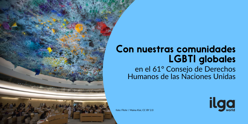 Foto de la Sala XX del Palacio de las Naciones en Ginebra. El texto dice: «Con nuestras comunidades LGBTI globales durante el 61.º Consejo de Derechos Humanos de la ONU». El logotipo de ILGA World aparece en la parte inferior derecha de la imagen.