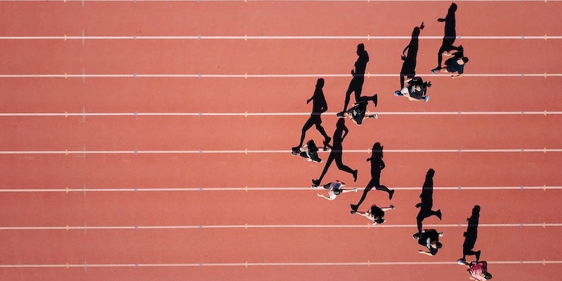 Group of people running in a stadium